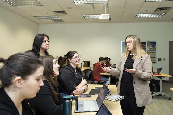 Cortney Rinker works with her students in their Diplomacy Lab course. Photo by Ron Aira/Office of University Branding.